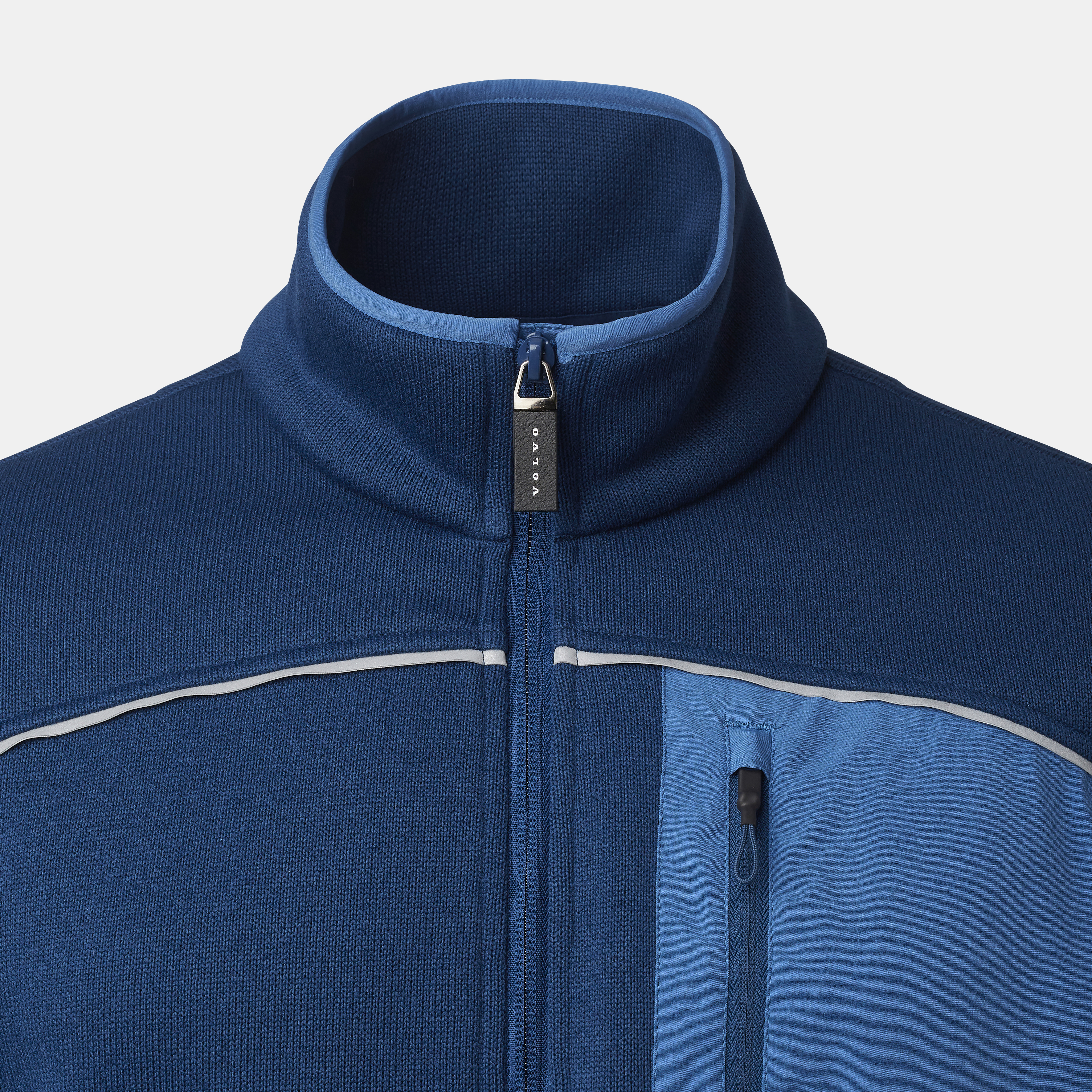 Close up of collar on the blue Volvo performance jacket, zip puller in center displaying Volvo logo