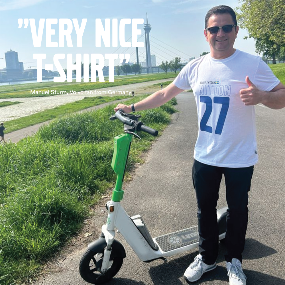Man wearing white and blue 1927 Volvo merchandise t-shirt