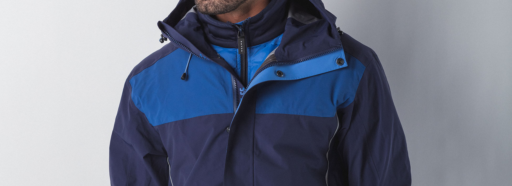 Waterproof Volvo Merchandise jacket on male model in blue and navy.