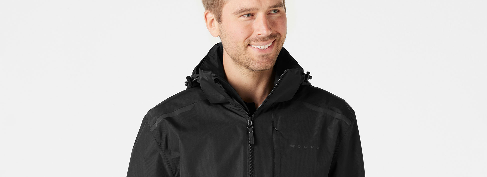 Man wearing black Volvo merchandise jacket.