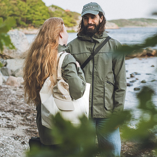 Couple wearing Volvo clothes in coastal landscape