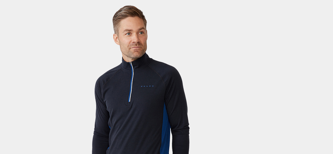 Man wearing a dark blue Merino wool Volvo pullover with zip neck